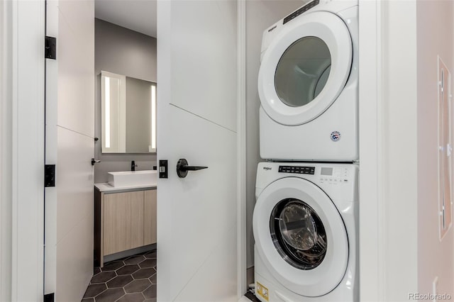 1901 Wazee St Unit 707, Denver, CO 80202 - laundry area featuring estacked washer and dryer and dark tile patterned flooring