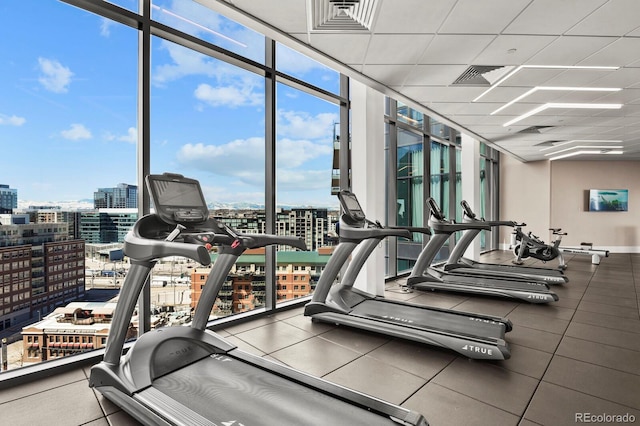 1901 Wazee St Unit 707, Denver, CO 80202 - workout area featuring a wall of windows, plenty of natural light, a city view, and a paneled ceiling