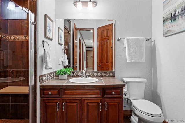 bathroom featuring vanity, toilet, and an enclosed shower