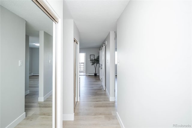 9155 E Center Ave Unit 4B, Denver, CO 80247 - corridor with light wood-style flooring and baseboard heating