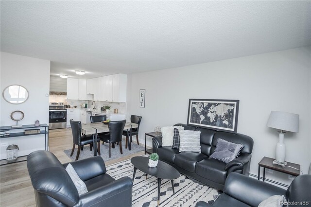 9155 E Center Ave Unit 4B, Denver, CO 80247 - living area with light wood-type flooring and a textured ceiling