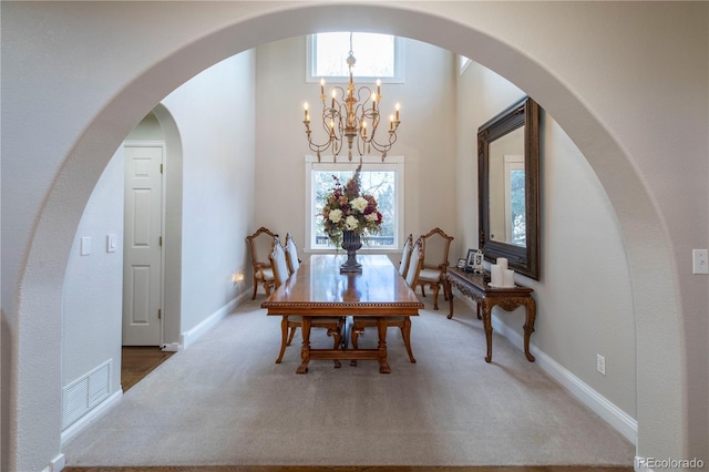 dining room with an inviting chandelier and carpet