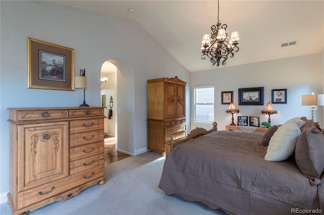 bedroom featuring vaulted ceiling, light colored carpet, and a chandelier