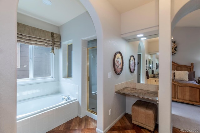 bathroom featuring hardwood / wood-style floors and shower with separate bathtub