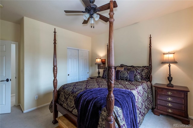 bedroom featuring ceiling fan, a closet, and light carpet