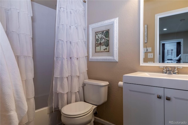 full bathroom featuring shower / tub combo with curtain, vanity, and toilet