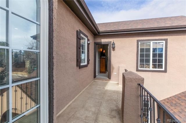 2675 Timberchase Trl, Highlands Ranch, CO 80126 - view of exterior entry featuring a shingled roof and stucco siding