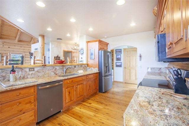 514 Little Baldy Cir, Fairplay, CO 80440 - kitchen featuring appliances with stainless steel finishes, light wood-type flooring, a sink, light stone countertops, and rustic walls