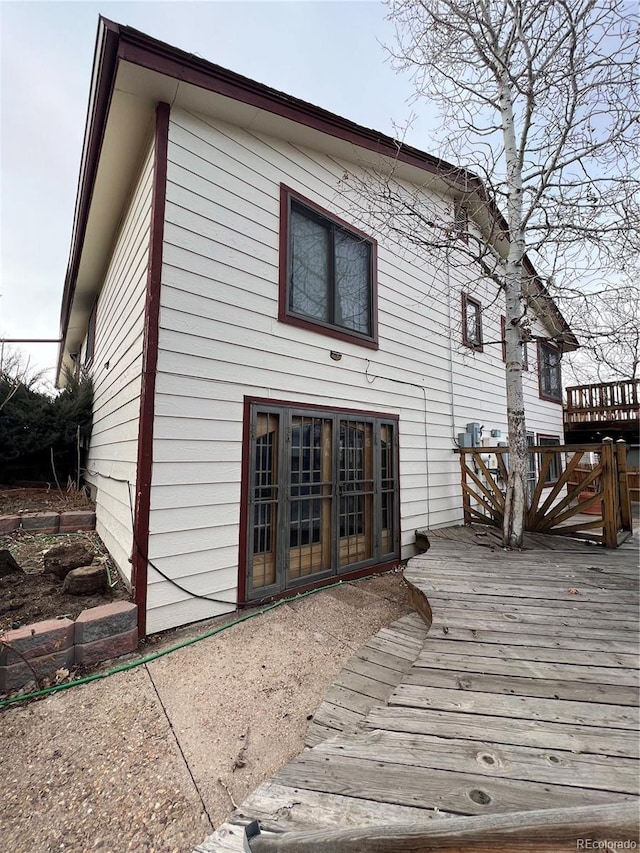 back of house featuring a wooden deck