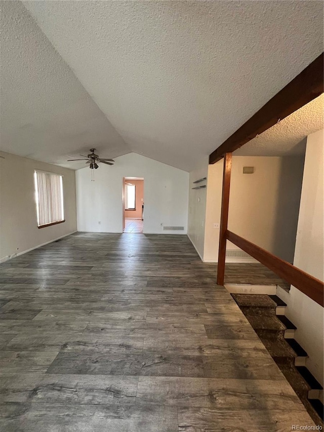 interior space with plenty of natural light, lofted ceiling, dark wood-style flooring, and ceiling fan