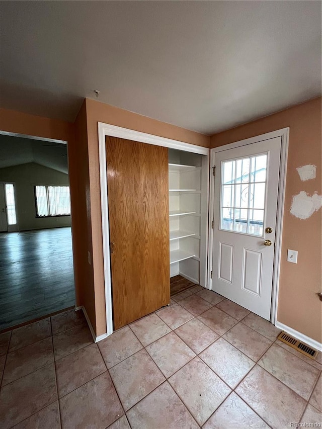 entryway with visible vents, baseboards, and light tile patterned flooring