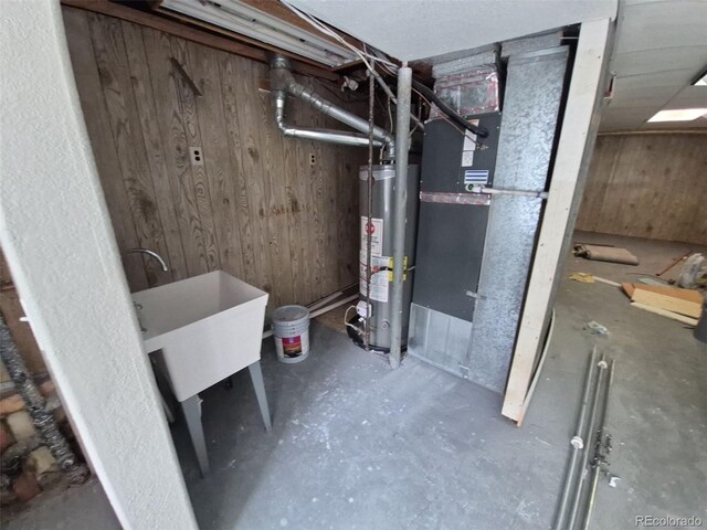 2758 S Salida St, Aurora, CO 80013 - unfinished basement featuring water heater, wooden walls, and a sink