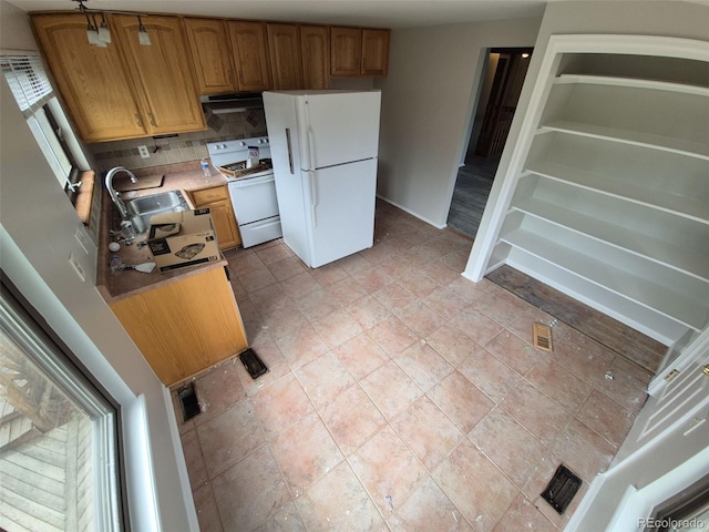 2758 S Salida St, Aurora, CO 80013 - kitchen featuring white appliances, exhaust hood, backsplash, a sink, and light countertops