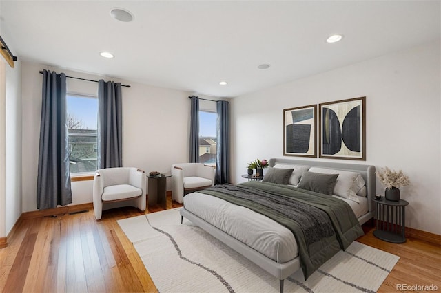 bedroom with recessed lighting, light wood-style floors, and baseboards