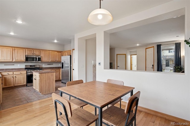 dining space featuring baseboards, recessed lighting, and wood finished floors