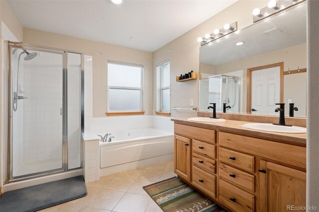 bathroom with tile patterned floors, a garden tub, a sink, and a stall shower