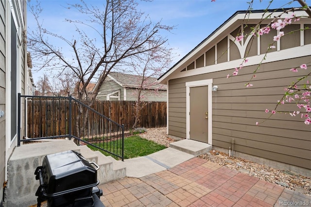 view of patio featuring fence and area for grilling
