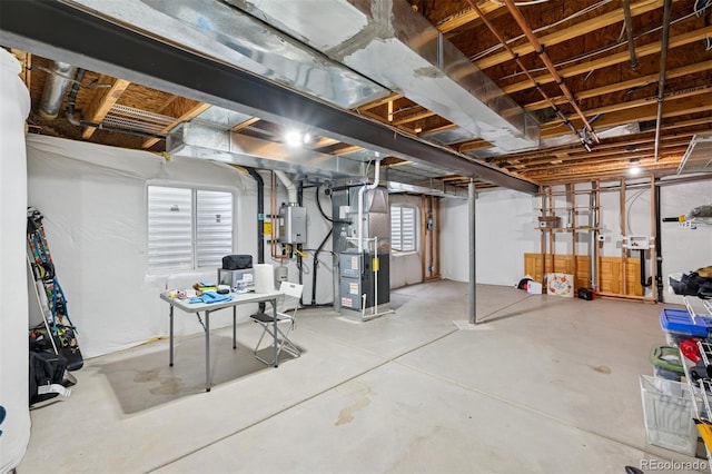 below grade area featuring water heater and heating unit