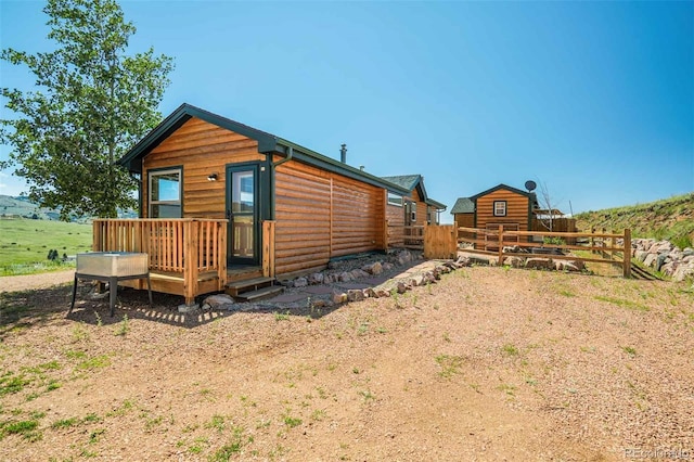 rear view of house with a wooden deck