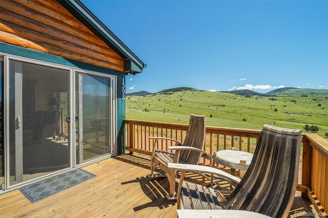 wooden terrace featuring a mountain view and a rural view