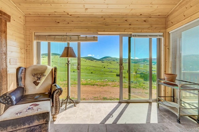 sunroom with vaulted ceiling, wood ceiling, and a mountain view