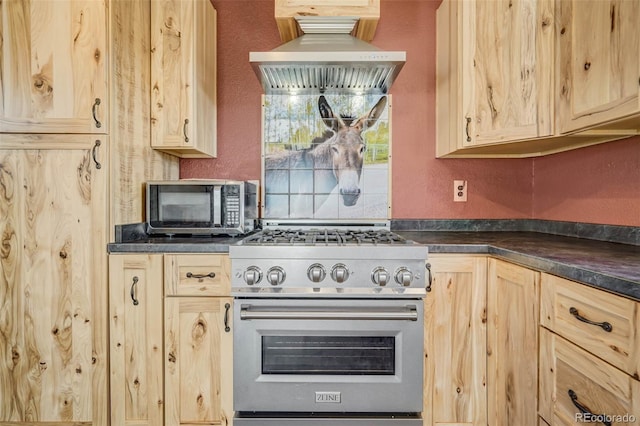 kitchen with exhaust hood, light brown cabinets, and high end stove