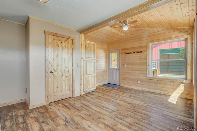 entryway featuring wooden walls, wooden ceiling, ceiling fan, wood-type flooring, and lofted ceiling with beams