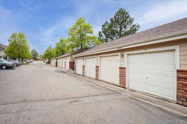 16848 E Gunnison Dr Unit 9E, Aurora, CO 80017 - view of asphalt road with community garages
