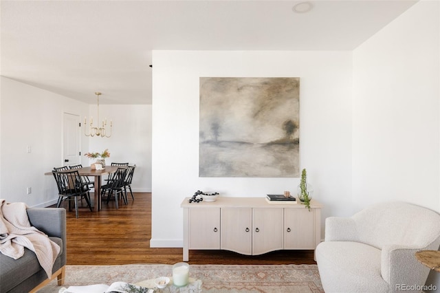 living room with wood-type flooring and a notable chandelier