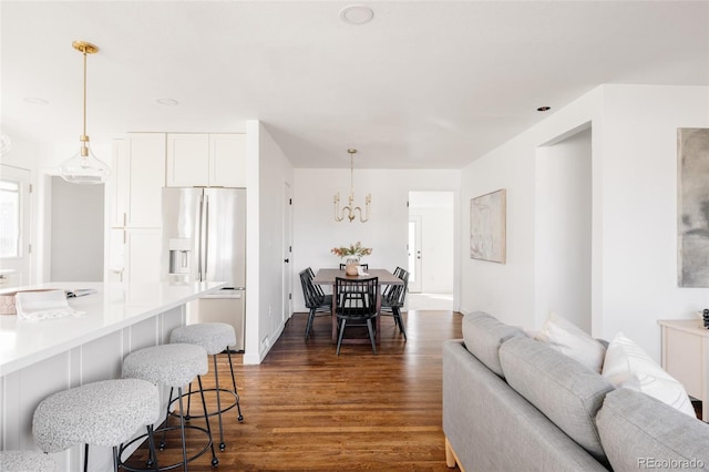 interior space with dark wood-type flooring and a chandelier