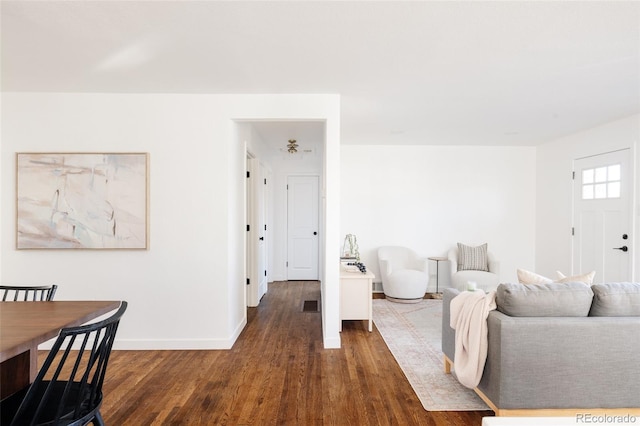 living room with dark hardwood / wood-style flooring