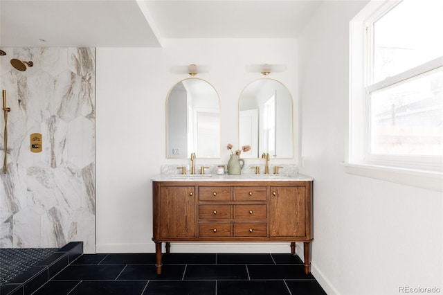 bathroom featuring tiled shower, vanity, and tile patterned floors