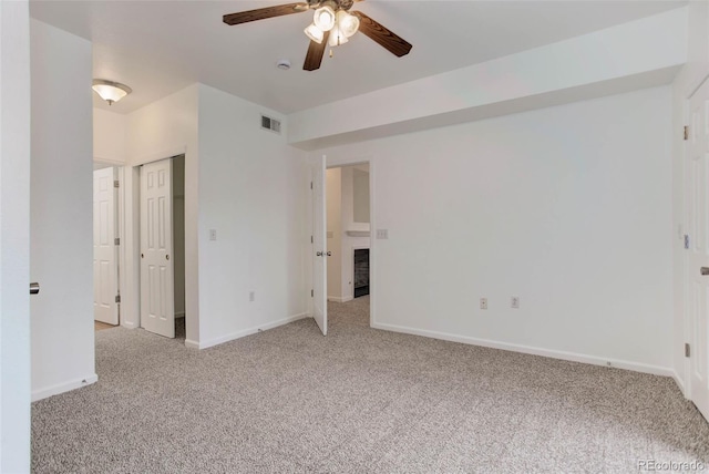 unfurnished bedroom featuring visible vents, light carpet, and baseboards