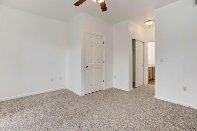 unfurnished bedroom featuring a ceiling fan, light colored carpet, and baseboards