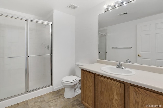 bathroom featuring visible vents, a shower stall, toilet, and vanity