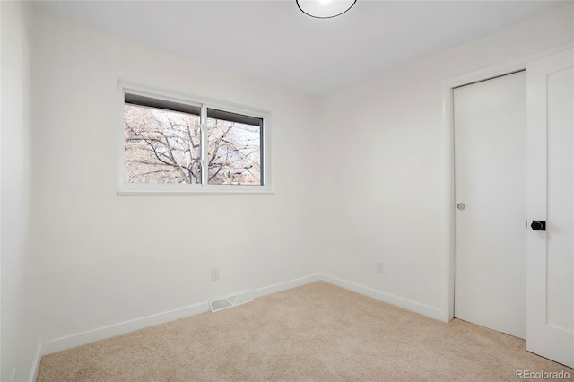 unfurnished bedroom with carpet floors, baseboards, visible vents, and a closet