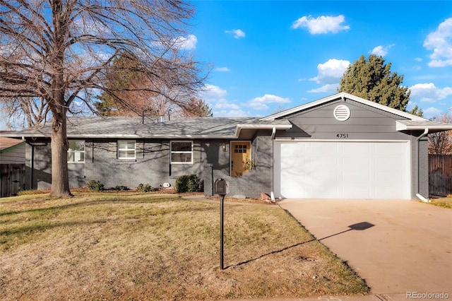 ranch-style house featuring a front yard, concrete driveway, fence, and an attached garage