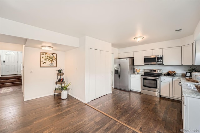 13020 E Linvale Pl, Aurora, CO 80014 - kitchen featuring stainless steel appliances, visible vents, baseboards, light stone countertops, and dark wood-type flooring