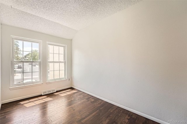 13020 E Linvale Pl, Aurora, CO 80014 - unfurnished room with a textured ceiling, visible vents, baseboards, and dark wood-style floors