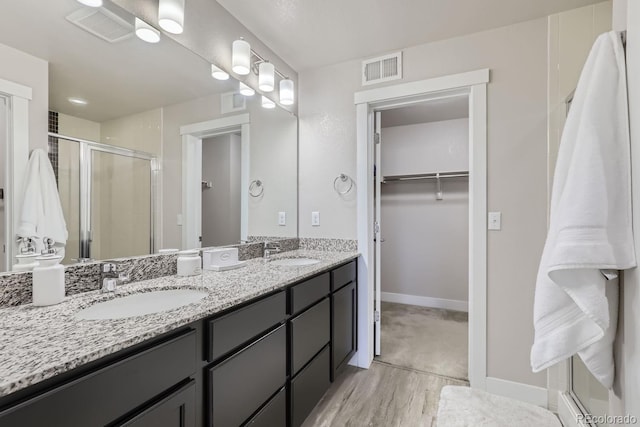 bathroom with an enclosed shower and vanity