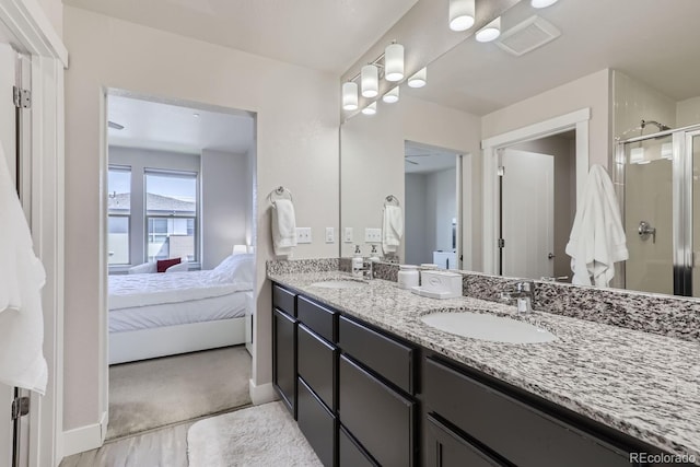 bathroom with vanity and a shower with shower door