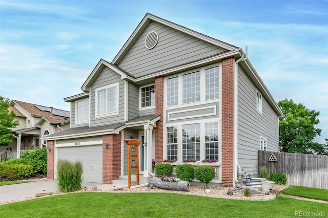 20710 E Princeton Pl, Aurora, CO 80013 - view of front facade with brick siding, an attached garage, and driveway