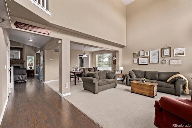 20710 E Princeton Pl, Aurora, CO 80013 - living area with dark wood-type flooring, high vaulted ceiling, and a fireplace