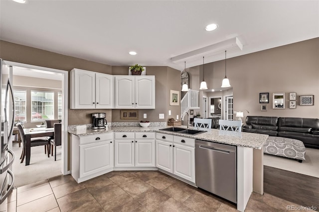 20710 E Princeton Pl, Aurora, CO 80013 - kitchen with appliances with stainless steel finishes, a peninsula, white cabinets, open floor plan, and light stone countertops