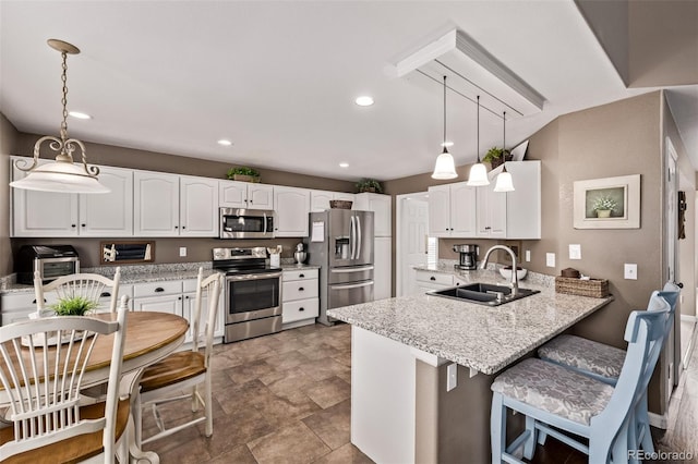 20710 E Princeton Pl, Aurora, CO 80013 - kitchen featuring appliances with stainless steel finishes, a peninsula, white cabinets, light stone countertops, and a breakfast bar area