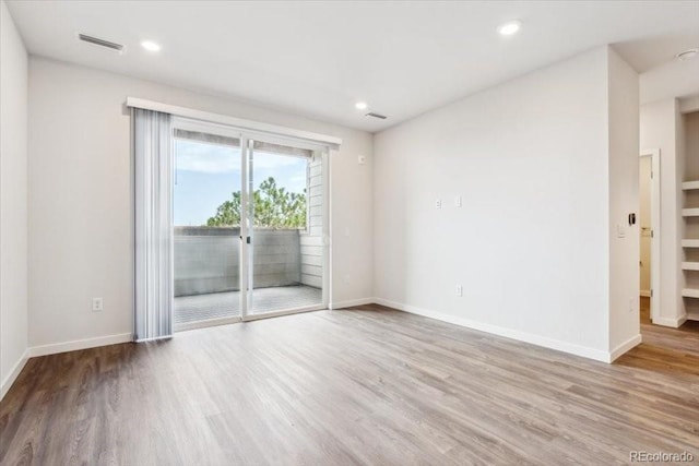 485 Interlocken Blvd Unit 201, Broomfield, CO 80021 - spare room featuring wood finished floors, baseboards, and recessed lighting