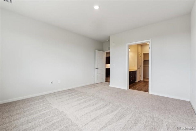 485 Interlocken Blvd Unit 201, Broomfield, CO 80021 - unfurnished bedroom with light carpet, baseboards, ensuite bath, and recessed lighting