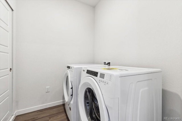 485 Interlocken Blvd Unit 201, Broomfield, CO 80021 - laundry room featuring washing machine and dryer, dark wood-style floors, and baseboards