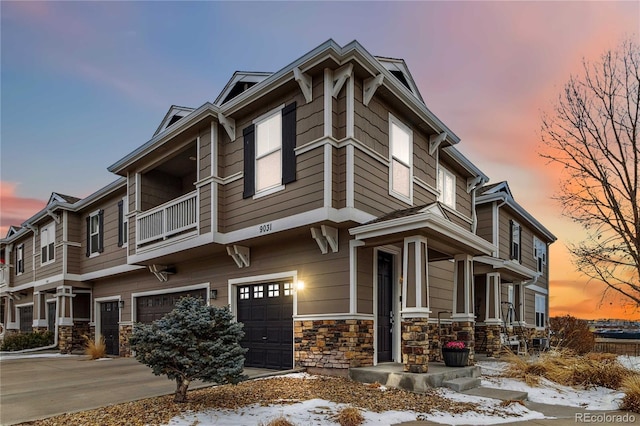 view of front facade featuring an attached garage and stone siding