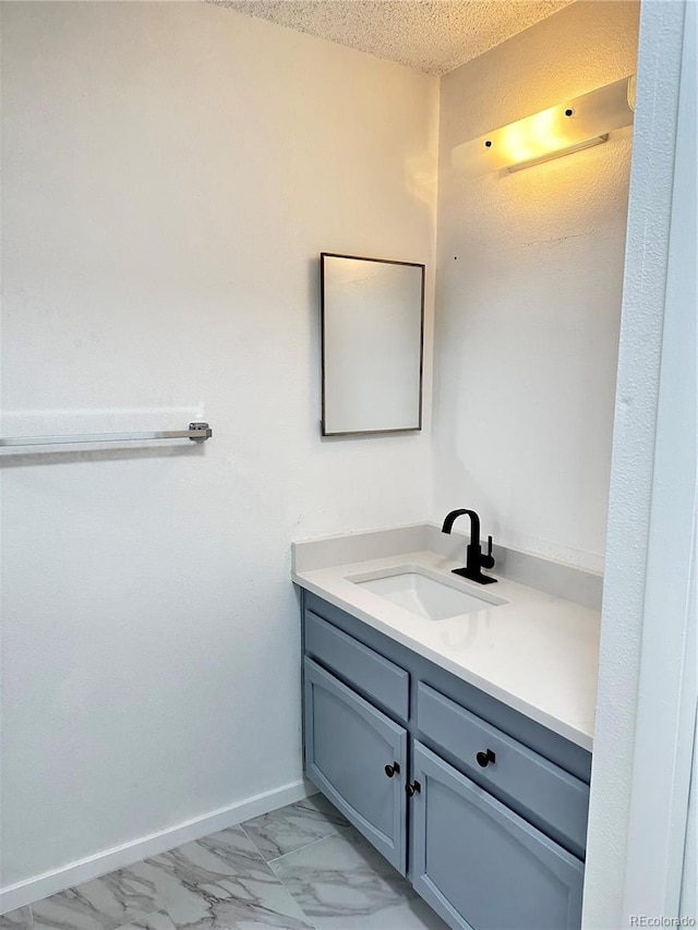 bathroom with vanity and a textured ceiling